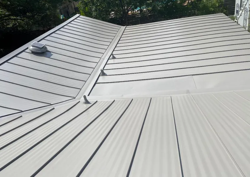 Solar attic fan installed on a metal roof for Roof Ventilation in Wonder Lake